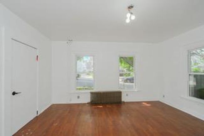 Empty room featuring radiator and wood finished floors | Image 20