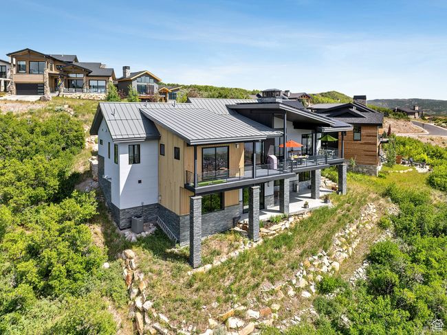 Back of house with a standing seam roof, a balcony, a metal roof, and a patio | Image 4