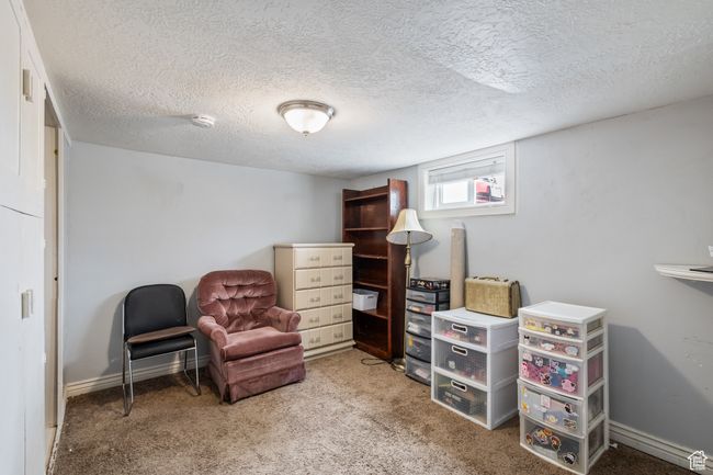Bedroom featuring a textured ceiling, carpet flooring, and baseboards | Image 15