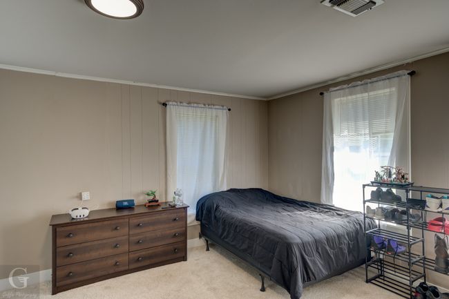 Carpeted bedroom with crown molding | Image 21