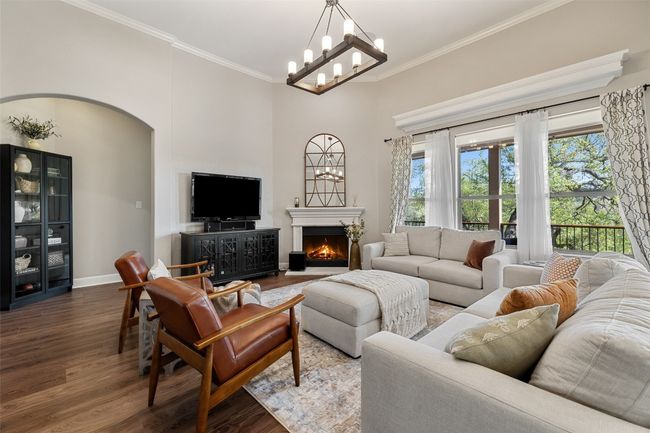 Living room featuring crown molding, wood finished floors, and a healthy amount of sunlight | Image 8