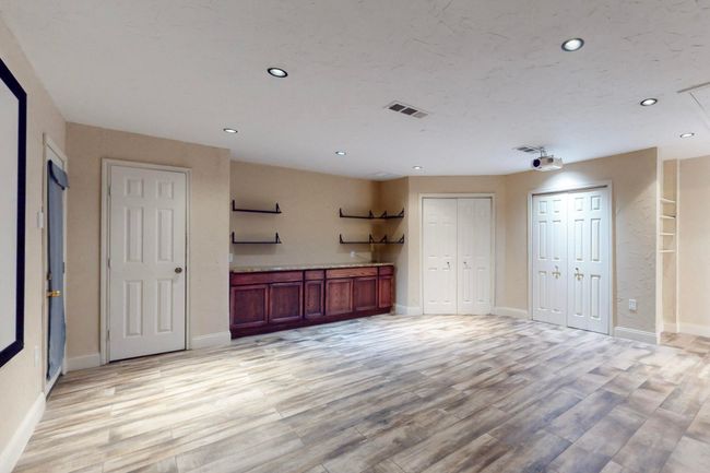 Unfurnished living room featuring recessed lighting, light wood-style flooring, baseboards, and visible vents | Image 16