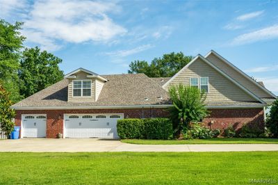 Garage entry and parking pad on left side of home | Image 3