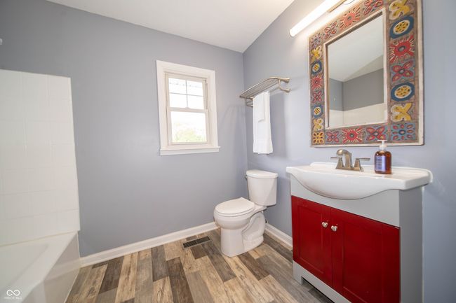 bathroom featuring baseboards, wood finished floors, toilet, and vanity | Image 32