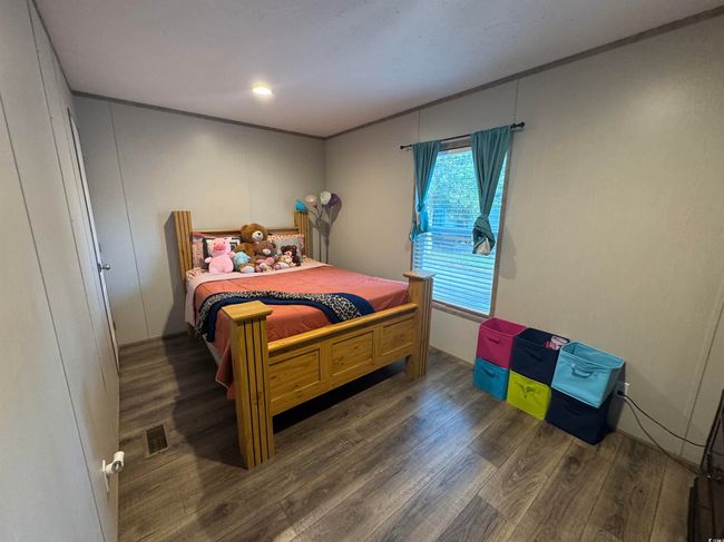 Bedroom with wood finished floors | Image 17