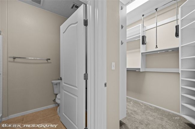 Bathroom with baseboards, visible vents, toilet, and tile patterned flooring | Image 29