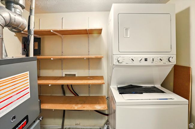 Laundry area with stacked washing machine and dryer | Image 22