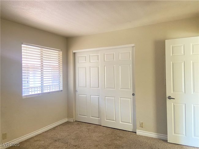 Unfurnished bedroom with a closet, baseboards, and carpet flooring | Image 13