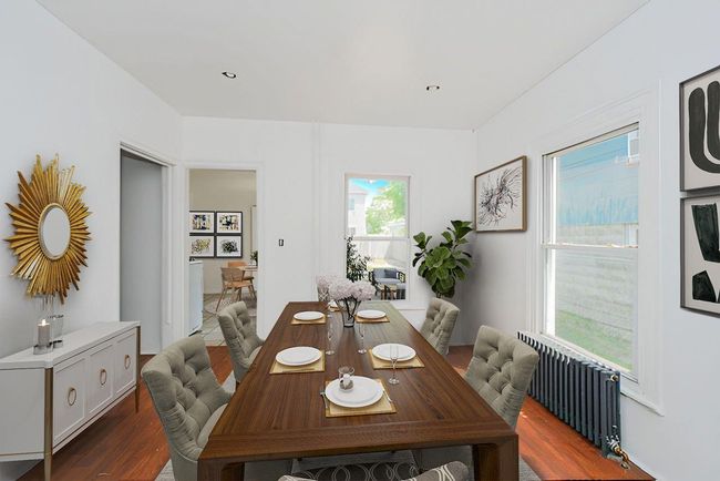 Dining space with wood finished floors and radiator | Image 13
