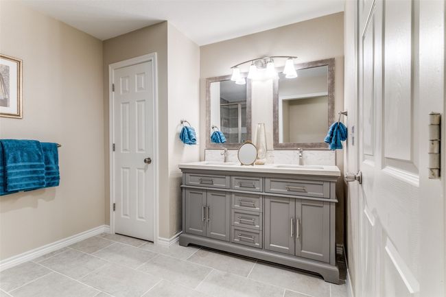 Bathroom featuring double vanity, tile patterned floors, and a shower | Image 20