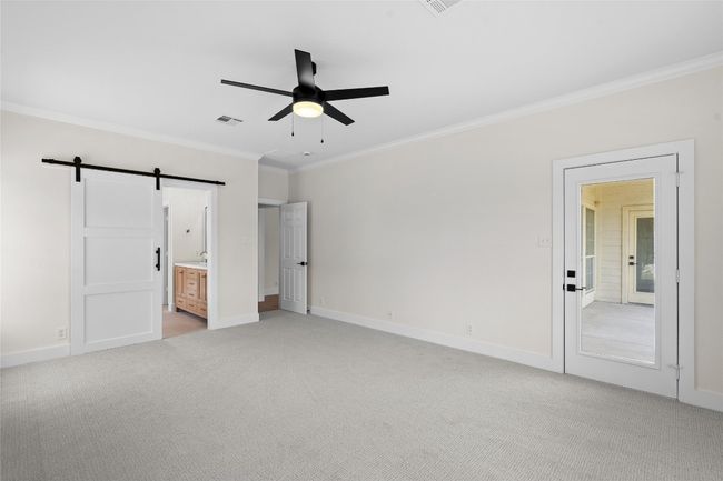 Master bedroom with access to back porch and barn doors into master bathroom | Image 20