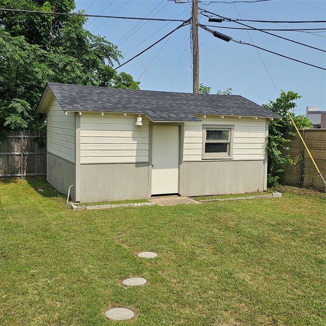 View of outdoor structure, Shed has a window unit, electricity, and gas line. | Image 26
