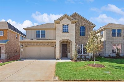 View of front of house with a garage and a front lawn | Image 1