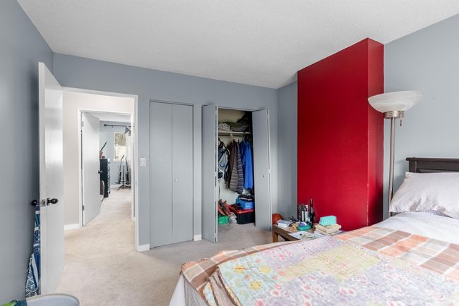 Bedroom featuring two closets, baseboards, carpet, and a textured ceiling | Image 14