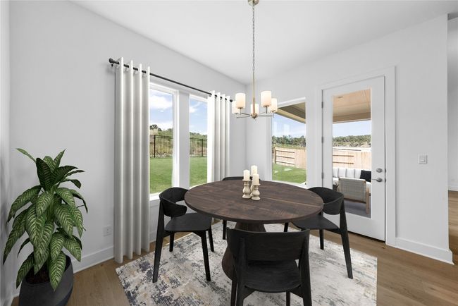 Dining room with a chandelier and light wood-type flooring | Image 6