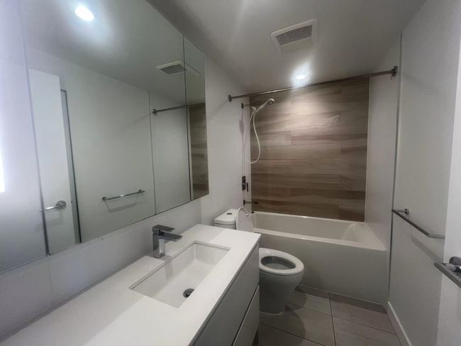 Bathroom featuring vanity, tile patterned floors, and bathtub / shower combination | Image 16