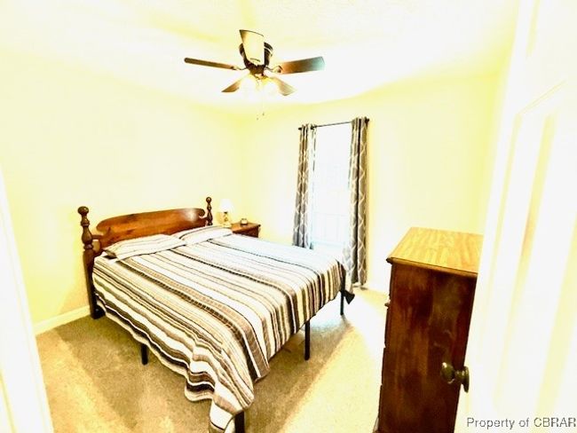 Bedroom featuring carpet flooring, ceiling fan, and baseboards | Image 9
