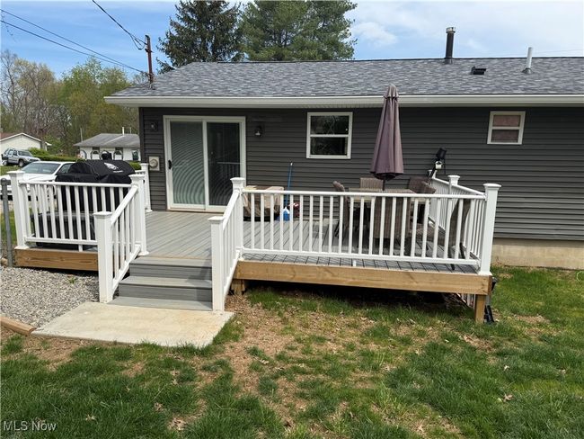 Rear view of house with a shingled roof, a yard, and a deck | Image 20