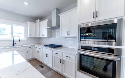 This kitchen is a chefs dream! Gas cooktop with a built oven and microwave. | Image 1