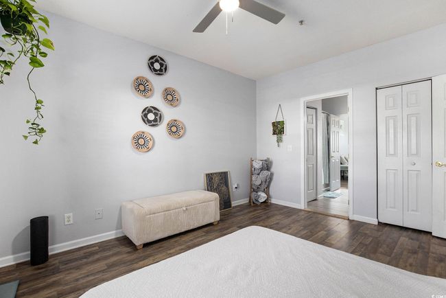 Bedroom with wood finished floors, baseboards, a ceiling fan, and a closet | Image 14
