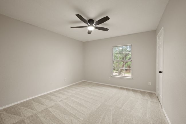 All of the bedrooms are spacious with large windows, fresh carpet, and modern ceiling fans. | Image 32