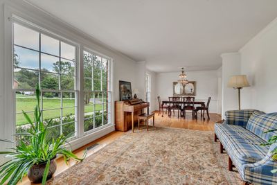 The Formal Living and Dining area is directly to the left of the entry foyer. The large floor to ceiling windows provide so much light to this already large welcoming space. | Image 2