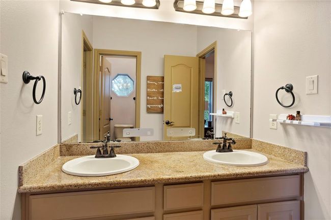 Connecting private bath with double sinks plus separate door to shower area for privacy. | Image 25