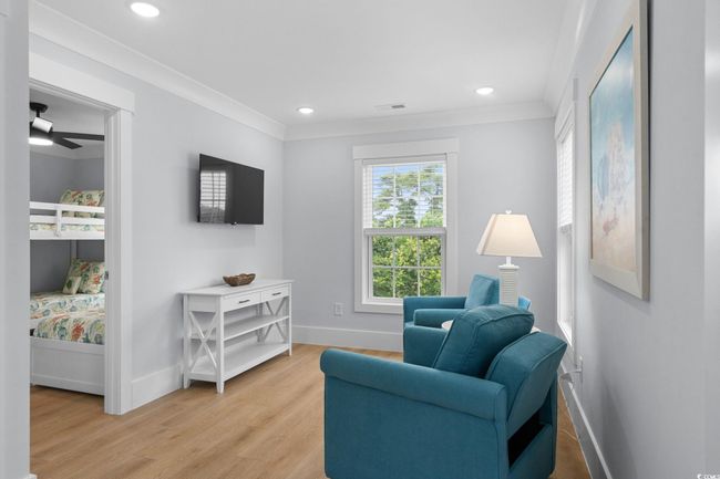 Living area with light wood-type flooring, ornamental molding, recessed lighting, and ceiling fan | Image 21