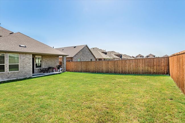 View of yard with a fenced backyard and a patio | Image 33
