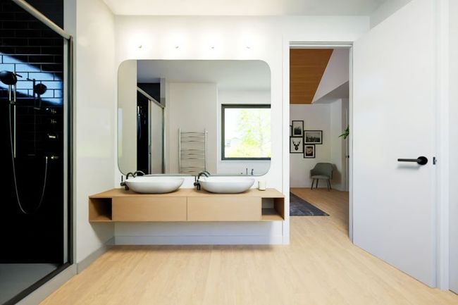 Modern ensuite bath featuring a floating dual-sink vanity and walk-in shower. | Image 17