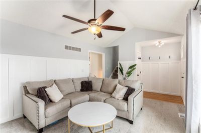 Living room with ceiling fan, light hardwood / wood-style flooring, and vaulted ceiling | Image 2