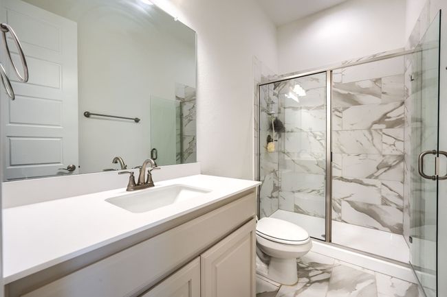 Full bath featuring marble finish floor, vanity, a marble finish shower, and toilet | Image 21