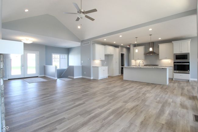 unfurnished living room featuring light wood-type flooring, baseboards, recessed lighting, visible vents, and ceiling fan | Image 8