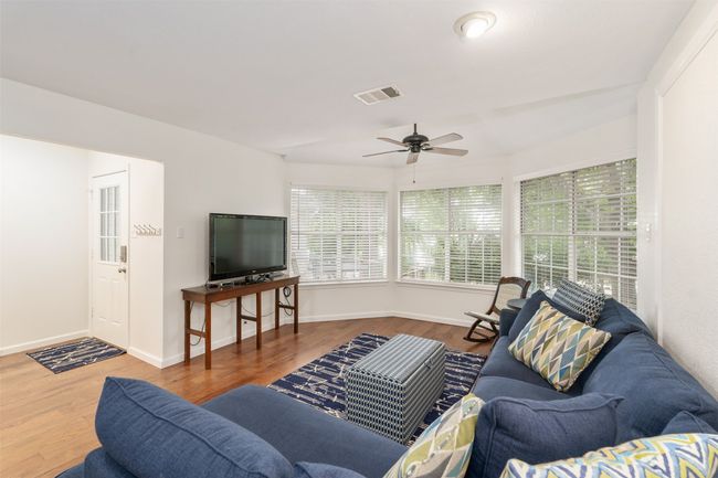 Living area featuring ceiling fan and wood finished floors | Image 7