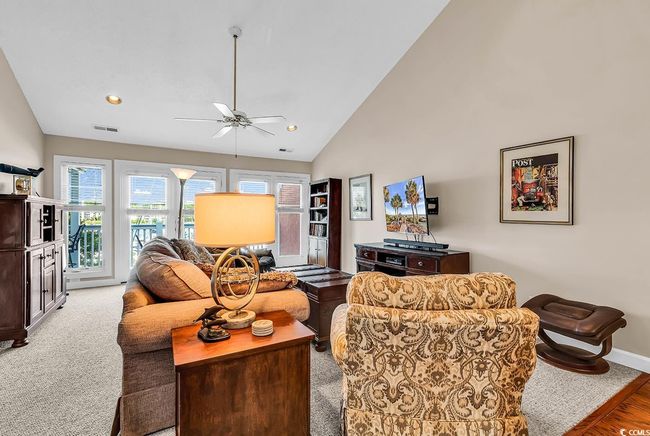 Living area featuring recessed lighting, visible vents, high vaulted ceiling, and ceiling fan | Image 10