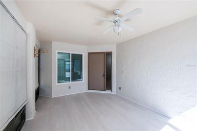 Welcoming screened-in entry porch with laminate flooring and plentry of area for seating and dining with the bonus of being in the fresh air. | Image 3