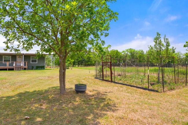 View of grassy yard featuring a deck | Image 21