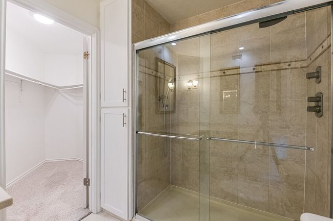 Bathroom featuring a shower stall and a walk in closet | Image 16