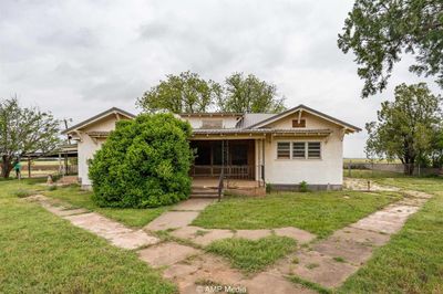 View of front of home featuring a front lawn and covered porch | Image 1