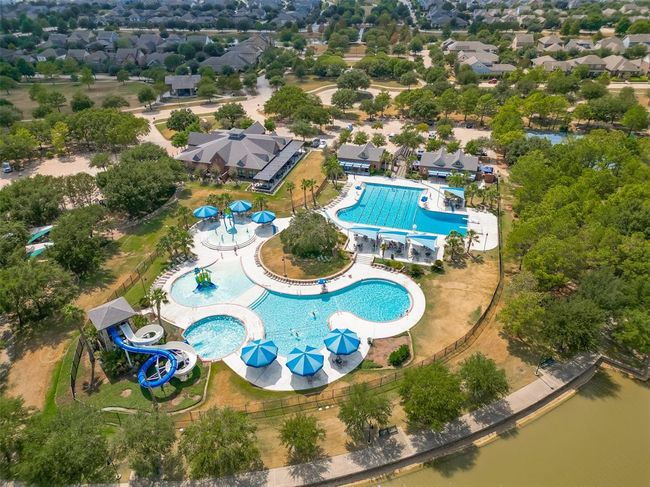 Features a single-family home with a spacious yard in Bridgeland, a master-planned community offering lakes, pools, sidewalks, and green spaces. | Image 28