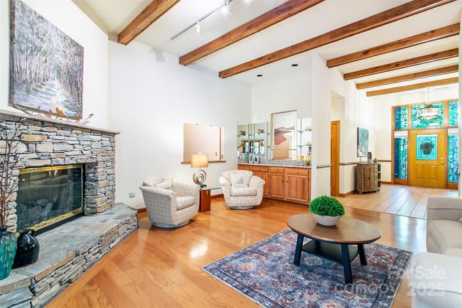 Warm up on winter nights next to this stone fireplace and enjoy the mini bar area tucked in the corner | Image 6