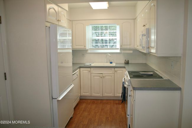 Kitchen with stove, dishwasher and large refrigerator | Image 8