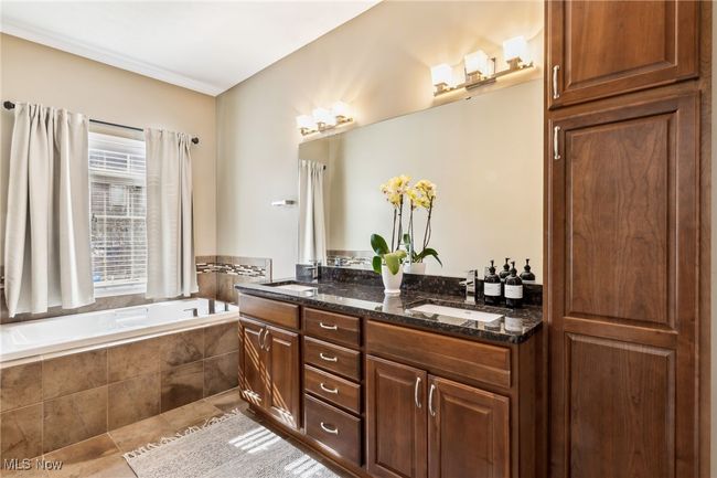 Primary suite bathroom with soaking tub and dual sinks | Image 21