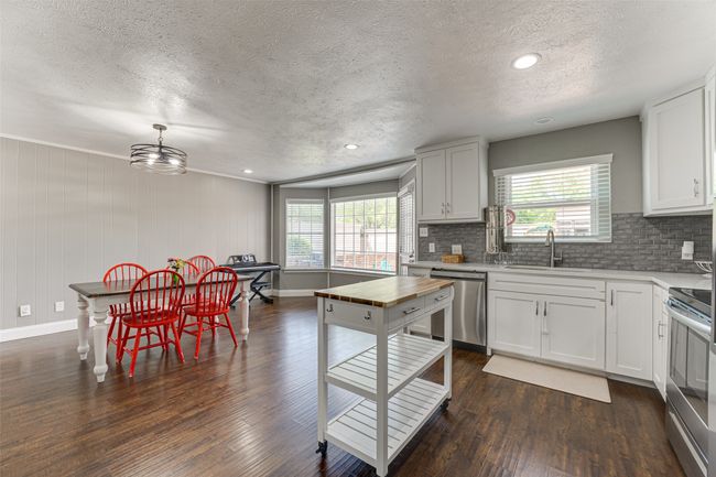 Kitchen featuring tasteful backsplash, a wealth of natural light, appliances with stainless steel finishes, and a textured ceiling | Image 12