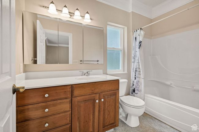 Full bath with vanity, crown molding, toilet, and shower / bath combination with curtain | Image 22