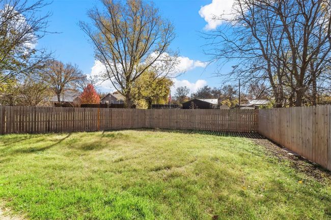 View of fenced backyard | Image 14