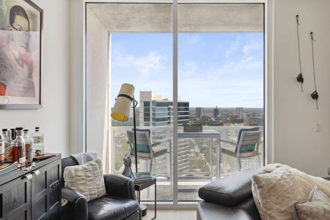 Sitting room featuring a wall of windows and a city view | Image 14