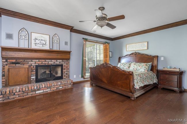 A brick fireplace is a feature in the main bedroom | Image 43