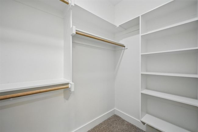 Walk in closet with carpet floors | Image 21