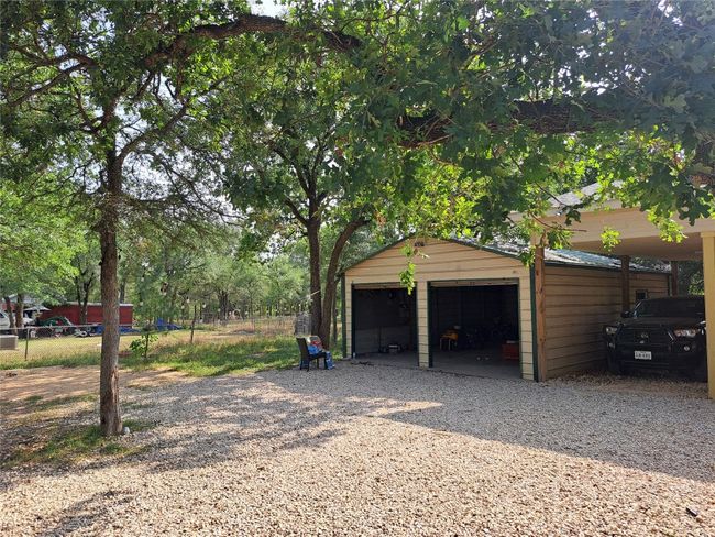 Garage with a detached garage and gravel driveway | Image 6